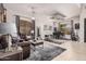 Open living room features tile flooring, leather sofa, and piano at 45247 W Jack Rabbit Trl, Maricopa, AZ 85139