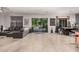 Open concept living room and dining area with sliding glass doors to the outdoor pool at 45247 W Jack Rabbit Trl, Maricopa, AZ 85139