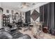 Spacious living room featuring sleek dark curtains, recording equipment, and ample seating at 45247 W Jack Rabbit Trl, Maricopa, AZ 85139