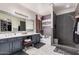 Stylish main bathroom with double vanity, soaking tub, and sleek glass-enclosed shower at 45247 W Jack Rabbit Trl, Maricopa, AZ 85139