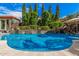 Beautiful pool with waterfall features and meticulously maintained landscaping, offering a serene and private retreat at 45247 W Jack Rabbit Trl, Maricopa, AZ 85139