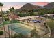 Expansive backyard with private pool, tennis court, and mountain views in this lovely estate at 4744 E Foothill Dr, Paradise Valley, AZ 85253