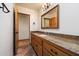 Bathroom vanity with wood cabinets, granite countertop, and ornate mirror at 4744 E Foothill Dr, Paradise Valley, AZ 85253