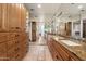 Expansive walk-in closet with wood cabinetry and drawers, granite countertop, mirrors, and tile flooring at 4744 E Foothill Dr, Paradise Valley, AZ 85253
