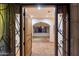 View of the entryway with travertine flooring, arched doorway, and custom light fixture at 4744 E Foothill Dr, Paradise Valley, AZ 85253