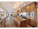 Spacious kitchen with stone tile flooring, wooden cabinetry, and a large island with granite countertops at 4744 E Foothill Dr, Paradise Valley, AZ 85253