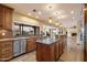 Kitchen featuring stainless steel appliances, custom wood cabinets, granite countertops, and designer pendant lighting at 4744 E Foothill Dr, Paradise Valley, AZ 85253