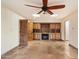 Spacious living room with tile floor, built-in shelving, fireplace, wooden door, and ceiling fan with lights at 4744 E Foothill Dr, Paradise Valley, AZ 85253