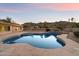 Refreshing backyard swimming pool with unique rock design, perfect for enjoying the desert scenery at 4744 E Foothill Dr, Paradise Valley, AZ 85253