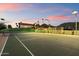 Nighttime view of tennis court next to main house, excellent for evening matches at 4744 E Foothill Dr, Paradise Valley, AZ 85253