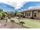 Private backyard featuring a putting green, mature landscaping, and a cozy lounging area at 5291 S Bradshaw Pl, Chandler, AZ 85249