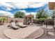 Well-maintained backyard with chaise lounges, gazebo, and a variety of mature trees and desert landscaping at 5291 S Bradshaw Pl, Chandler, AZ 85249