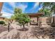 Beautifully landscaped backyard with mature trees, a cozy hammock, and serene garden accents at 5291 S Bradshaw Pl, Chandler, AZ 85249