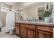 Bathroom featuring a classic vanity with a decorative backsplash and a shower-tub combo at 5291 S Bradshaw Pl, Chandler, AZ 85249