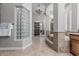 Bathroom showcasing a glass block window, soaking tub, and a glimpse into the closet at 5291 S Bradshaw Pl, Chandler, AZ 85249