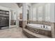 This bathroom showcases a soaking tub with decorative accents and plantation shutters for privacy at 5291 S Bradshaw Pl, Chandler, AZ 85249