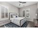Well-lit bedroom with shuttered windows, ceiling fan, and plush bedding and decor at 5291 S Bradshaw Pl, Chandler, AZ 85249
