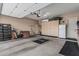 Spacious three car garage with storage cabinets, epoxy floors and ample space for vehicles and projects at 5291 S Bradshaw Pl, Chandler, AZ 85249