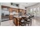 Spacious kitchen featuring a large island, stainless steel appliances, and wooden cabinetry with ample storage at 5291 S Bradshaw Pl, Chandler, AZ 85249