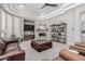 Inviting living room features a stone fireplace, modern furnishings, and a large, comfortable leather sofa at 5291 S Bradshaw Pl, Chandler, AZ 85249