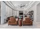Spacious and well-lit living room featuring a stone fireplace, comfortable seating, and coffered ceiling at 5291 S Bradshaw Pl, Chandler, AZ 85249