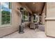 Covered patio offers an inviting area with outdoor dining set, heater, and serene garden views at 5291 S Bradshaw Pl, Chandler, AZ 85249