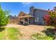 An expansive backyard offers ample space for recreation and relaxation under the covered patio at 6320 W Mercer Ln, Glendale, AZ 85304