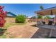 Spacious backyard with a patio, swing, fire pit, and lush greenery at 6320 W Mercer Ln, Glendale, AZ 85304