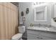 Charming bathroom with a granite vanity, framed mirror, updated hardware, and decorative accents at 6320 W Mercer Ln, Glendale, AZ 85304
