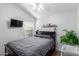 Cozy bedroom with a window, television, ample shelving, and natural light streaming in at 6320 W Mercer Ln, Glendale, AZ 85304