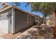 Charming single-story home with a gray exterior, a two-car garage, with dark colored trim at 6320 W Mercer Ln, Glendale, AZ 85304