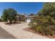 Charming single-story home with a gray exterior, a two-car garage, basketball hoop, and a well-manicured yard at 6320 W Mercer Ln, Glendale, AZ 85304