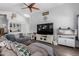 Bright and airy living room featuring a large TV, a cozy fireplace, and vaulted ceilings at 6320 W Mercer Ln, Glendale, AZ 85304