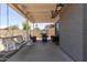 Covered patio featuring comfortable seating, a grill, and an outdoor dining area at 6320 W Mercer Ln, Glendale, AZ 85304
