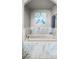 A marble soaking tub with grey artwork and matching accessories at 7199 E Ridgeview Pl # 221, Carefree, AZ 85377