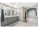 Large bathroom featuring double sinks, a walk-in shower with grey tile, and a soaking tub with marble surround at 7199 E Ridgeview Pl # 221, Carefree, AZ 85377