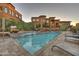 Beautiful community pool with waterfalls, plenty of seating, and lush desert landscaping at 7199 E Ridgeview Pl # 221, Carefree, AZ 85377