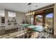 Dining room with custom table and open patio doors with mountain views at 7199 E Ridgeview Pl # 221, Carefree, AZ 85377