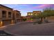 Paver driveway leading to desert homes with private garages, landscaping, and sconce lighting at 7199 E Ridgeview Pl # 221, Carefree, AZ 85377