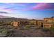 Scenic view of a beautiful homes and mountain range at sunset in distance at 7199 E Ridgeview Pl # 221, Carefree, AZ 85377