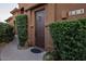 Inviting front entrance with manicured landscaping, desert plants and a charming brown door at 7199 E Ridgeview Pl # 221, Carefree, AZ 85377