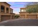 View of multi-car garages in a home with mature landscaping and desert trees at 7199 E Ridgeview Pl # 221, Carefree, AZ 85377