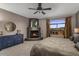 Comfortable bedroom with fireplace, blue dresser, carpet, and large view window with mountain views at 7199 E Ridgeview Pl # 221, Carefree, AZ 85377