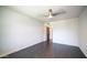 Spacious bedroom features laminate floors, a ceiling fan, and a view to the hall at 8008 N Central Ave # 10, Phoenix, AZ 85020