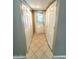 Hallway with tiled floor and lots of built-in closet space and access to the exterior at 814 S 80Th St, Mesa, AZ 85208