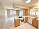 Galley kitchen featuring tile floors, natural wood cabinets, and bright natural light at 814 S 80Th St, Mesa, AZ 85208
