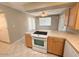 Kitchen featuring wood cabinets, tiled countertops, tile floors and modern appliances at 814 S 80Th St, Mesa, AZ 85208