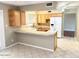 Bright kitchen with wood cabinets, tiled countertops, and a modern refrigerator at 814 S 80Th St, Mesa, AZ 85208