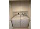 Laundry room featuring washer, dryer, and overhead storage cabinets at 814 S 80Th St, Mesa, AZ 85208