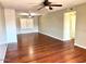 Spacious living room with hardwood floors, ceiling fan, and a view from the large window at 814 S 80Th St, Mesa, AZ 85208